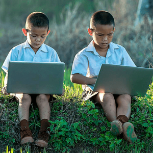 two children playing on gaming laptops