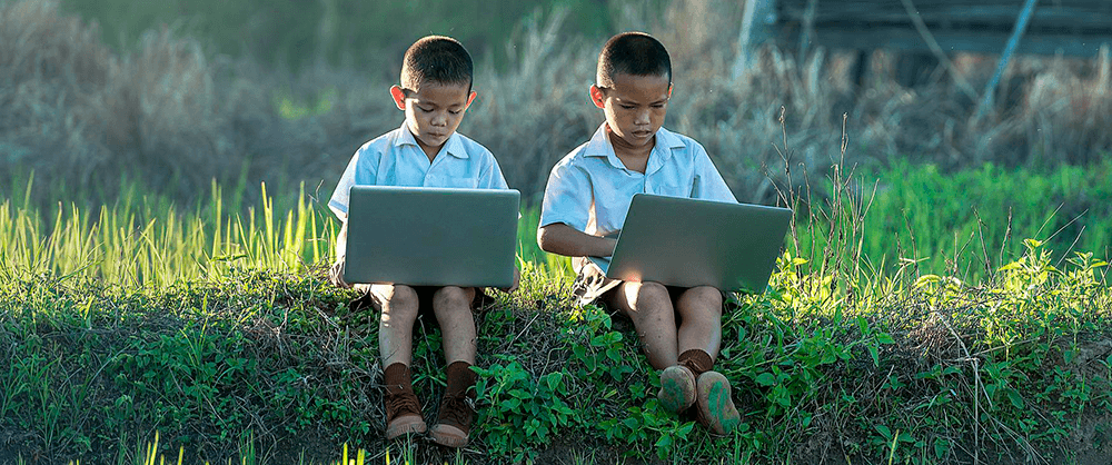 two children playing on gaming laptops